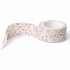 A roll of Multicolor Typography Luxe Washi Tape a white background and a colorful pattern of scattered cursive letters in pink, blue, yellow, and green, shown with one end unrolled.