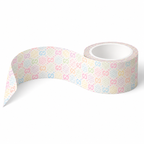 A roll of washi tape with a repeating pastel pattern of 'GG' Gucci letters and polka dots on a white background, shown with one end unrolled.